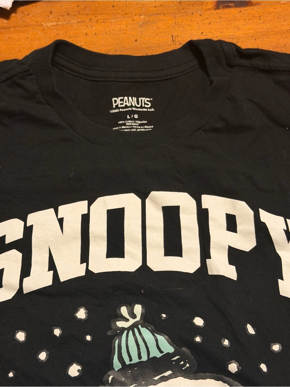 Peanuts woman’s Black Tee with Teal Snoopy Puffer Graphic - Picture 2 of 2